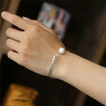 S925 sterling silver cat charm bracelet with round pearl bead on a slim bangle