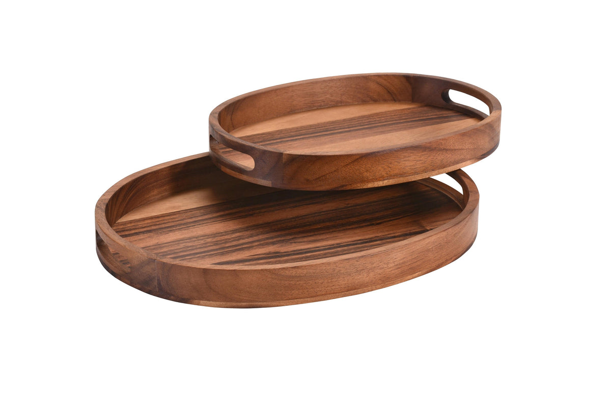 Stacked oval wooden serving trays with cutout side handles