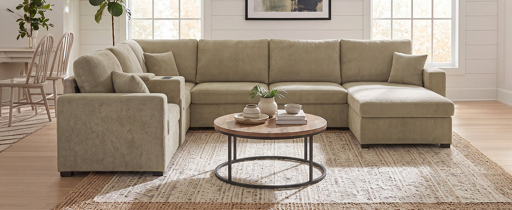 Beige modular sectional sofa with chaise extension and deep cushioned seats