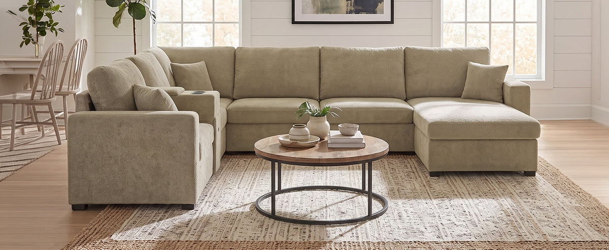 Beige modular sectional sofa with chaise extension and deep cushioned seats