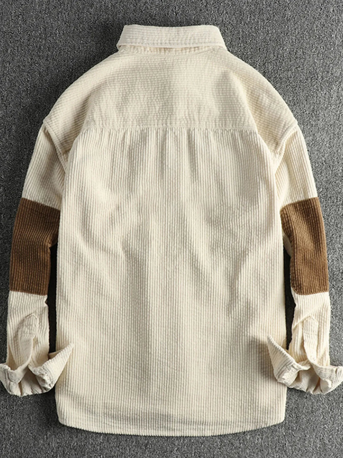 Back view of a plus-size corduroy button-up shirt in light beige with yoke and ribbed texture