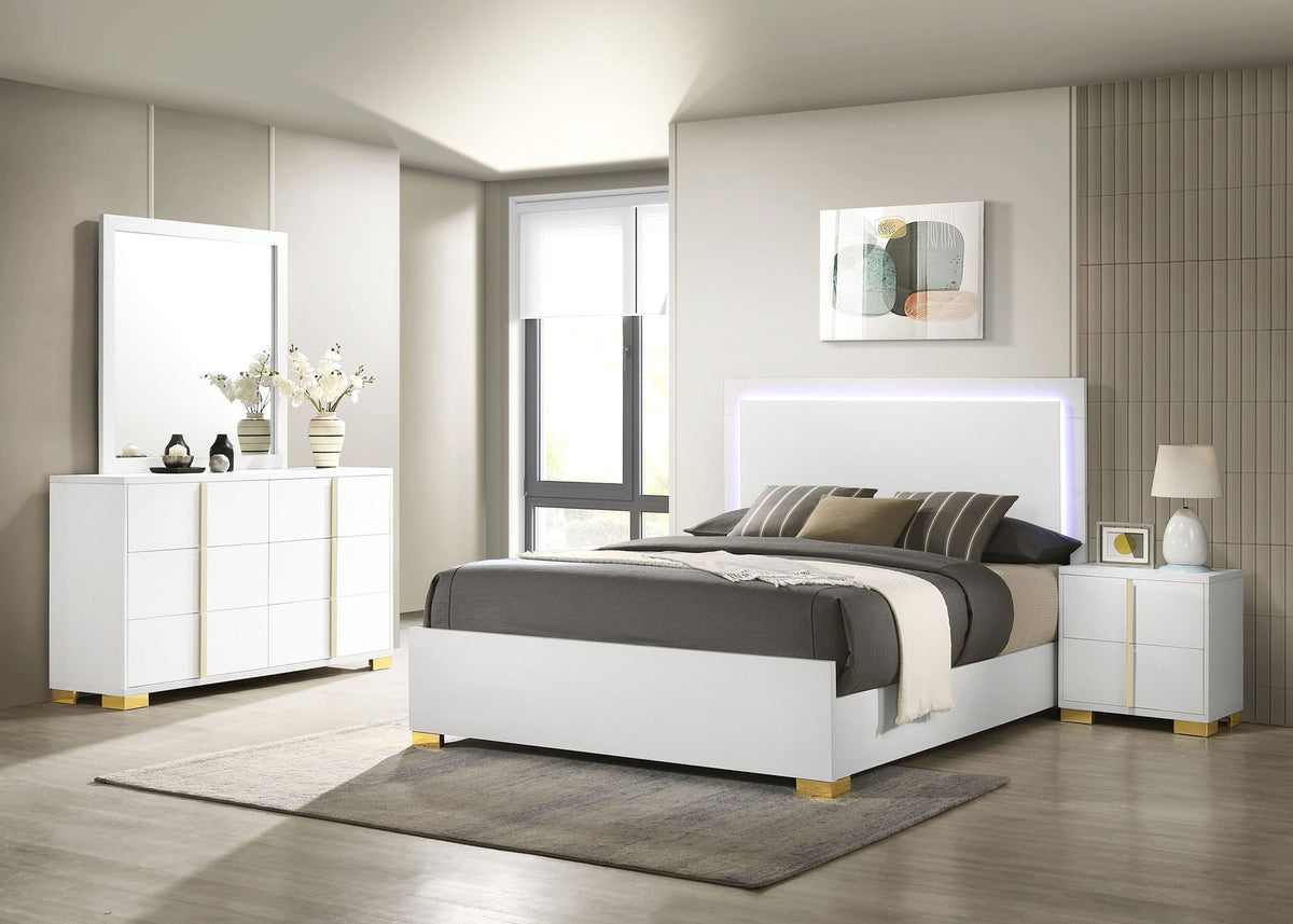 White queen bed frame with gray bedding, plus matching nightstands, dresser, and mirror