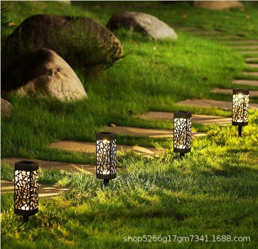 Set of black solar garden pathway lantern lights with cutout panels and glowing bulbs