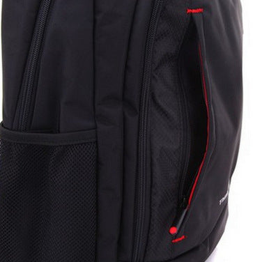 Black backpack close-up: mesh side panel, red piping, and two vertical zippers