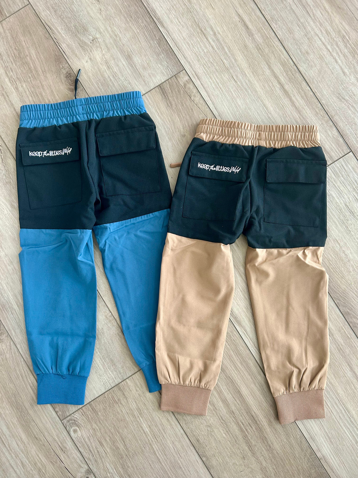 Kids hiking pants in navy and tan color-block with elastic waistband and cuffs