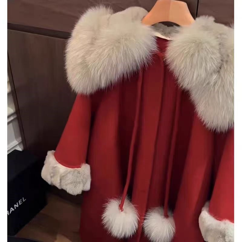 Red wool coat with fluffy fur cuffs and front pom-pom details