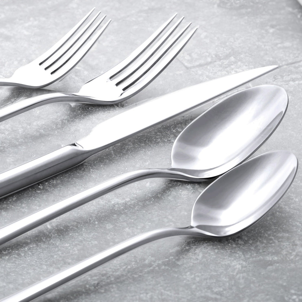 Close-up of silver mirror-finish flatware spoons and fork tines