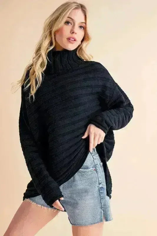 Black asymmetrical turtleneck sweater with long sleeves and side slit