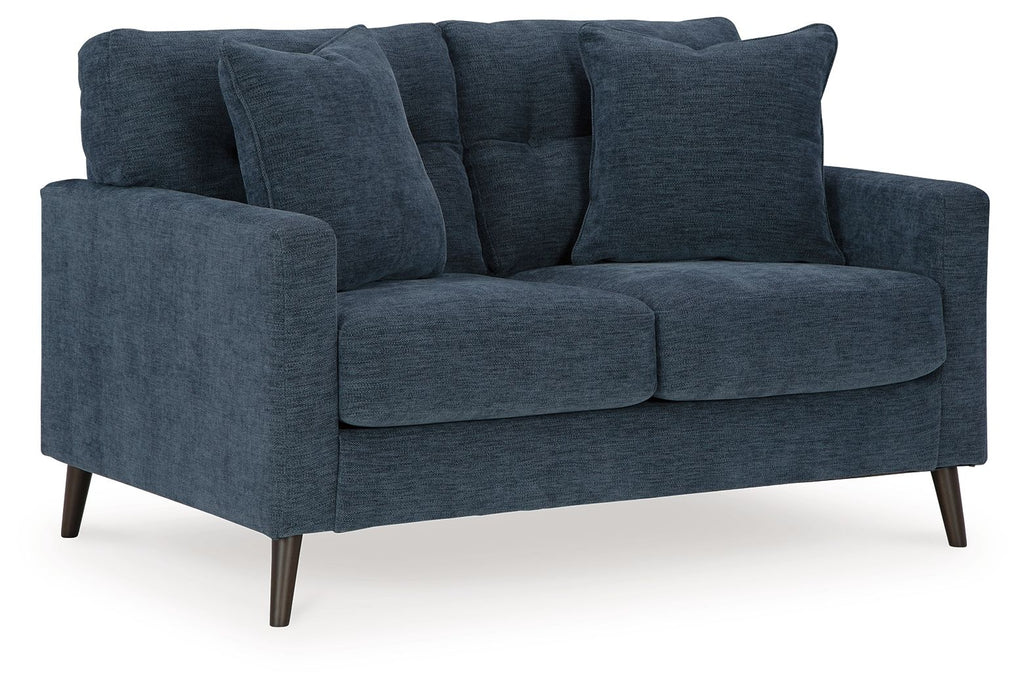 Blue fabric loveseat with plush cushions, rounded arms, and tapered wooden legs