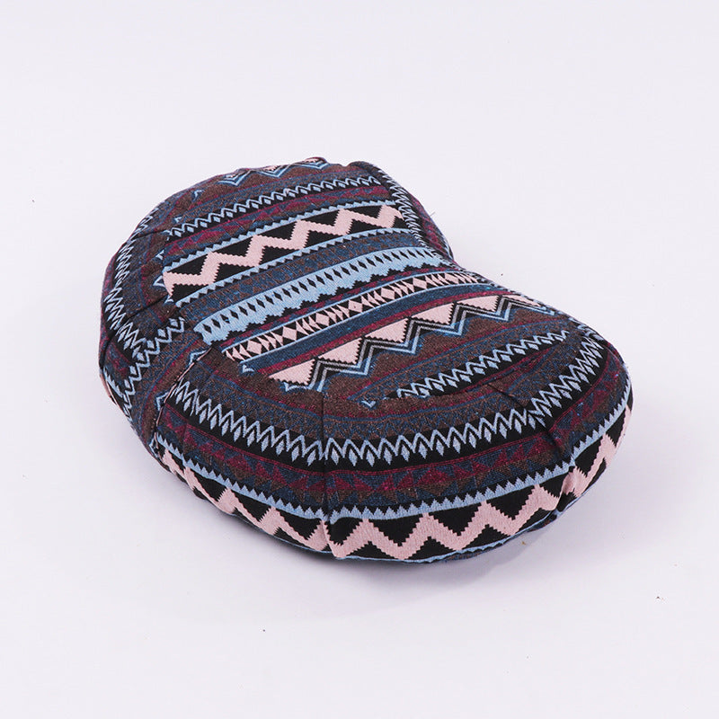 Geometric yoga meditation cushion, oval with navy, burgundy, white, and blue pattern