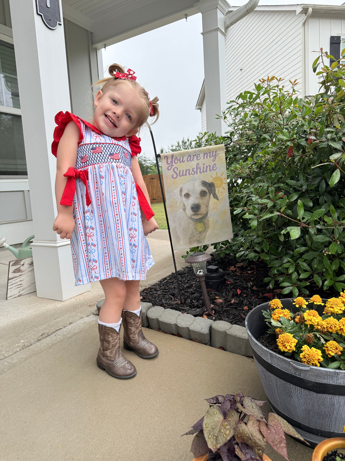 Girls patriotic smocked dress with red bow ties, blue striped skirt and ruffled sleeves