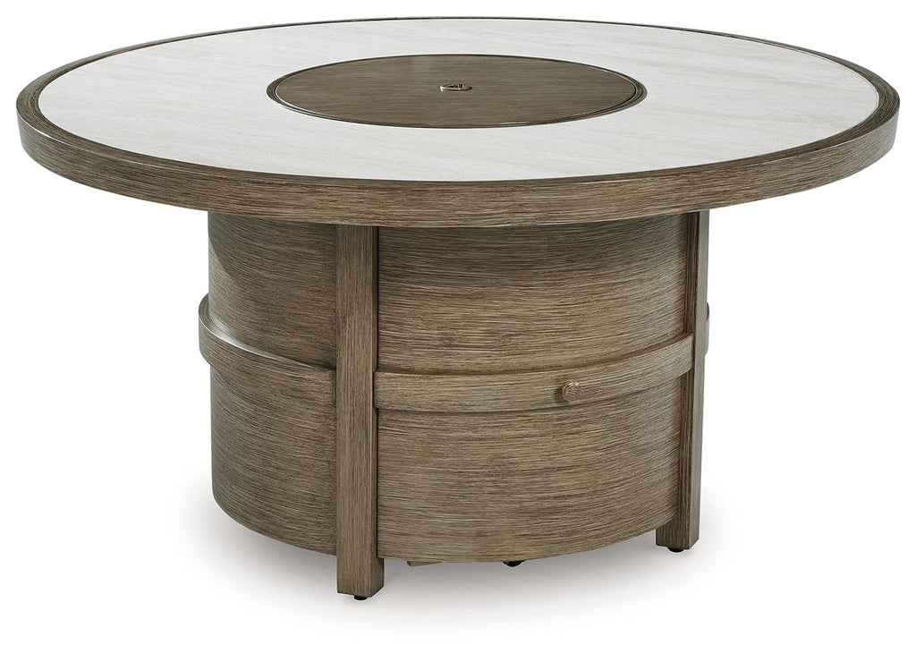Round fire pit table with beige top and dark circular burner in a wood pedestal