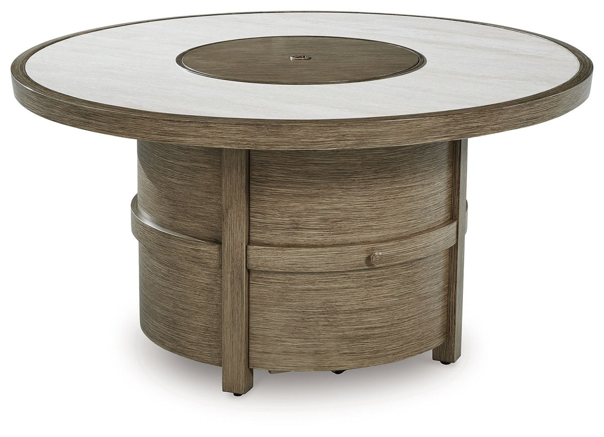 Round fire pit table with beige top and dark circular burner in a wood pedestal