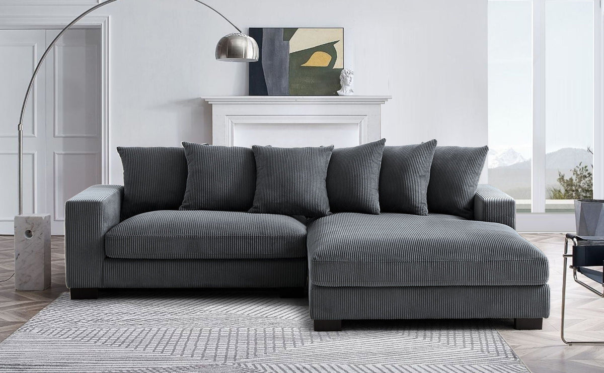 Charcoal gray L-shaped sectional sofa with chaise and five matching accent pillows.