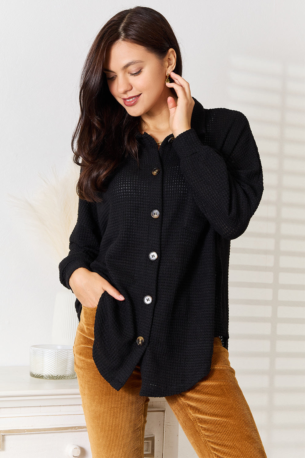 Black waffle-knit collared shirt with button front and long sleeves, slightly gathered hem