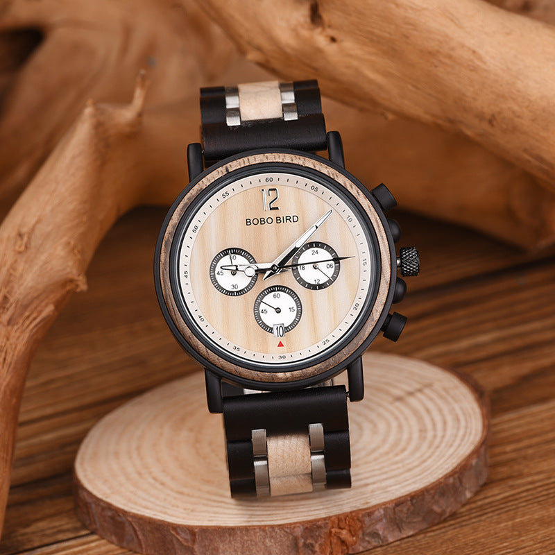 Round two-tone quartz wristwatch with black strap, beige inserts, and white chronograph dial
