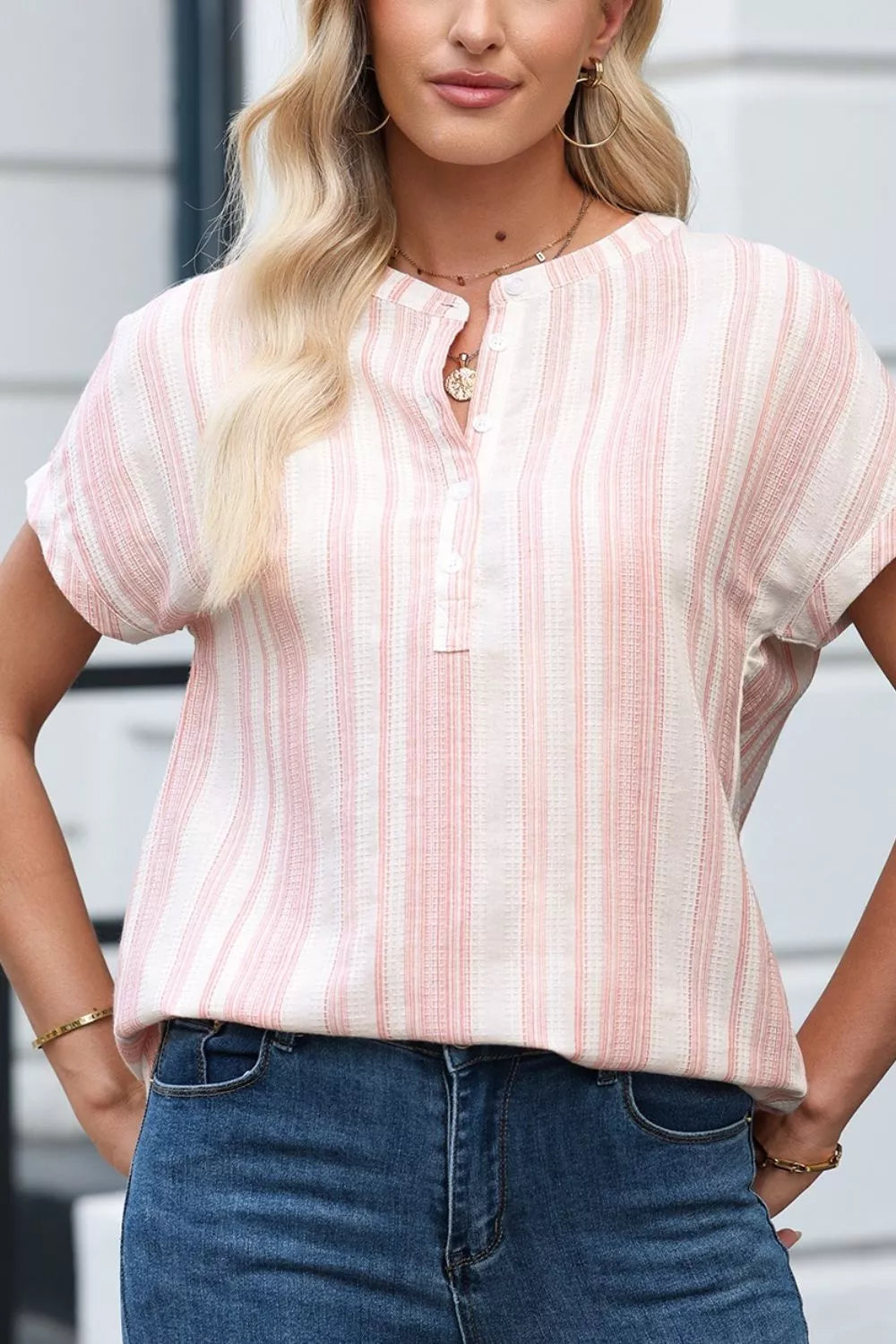 Dusty pink striped short-sleeve blouse with rounded neckline and button placket