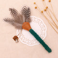 Cat chew stick toy with green textured wand, brown felt end, and gray feather sprig