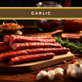 Garlic beef sticks, sliced on a wooden board with herbs and garlic