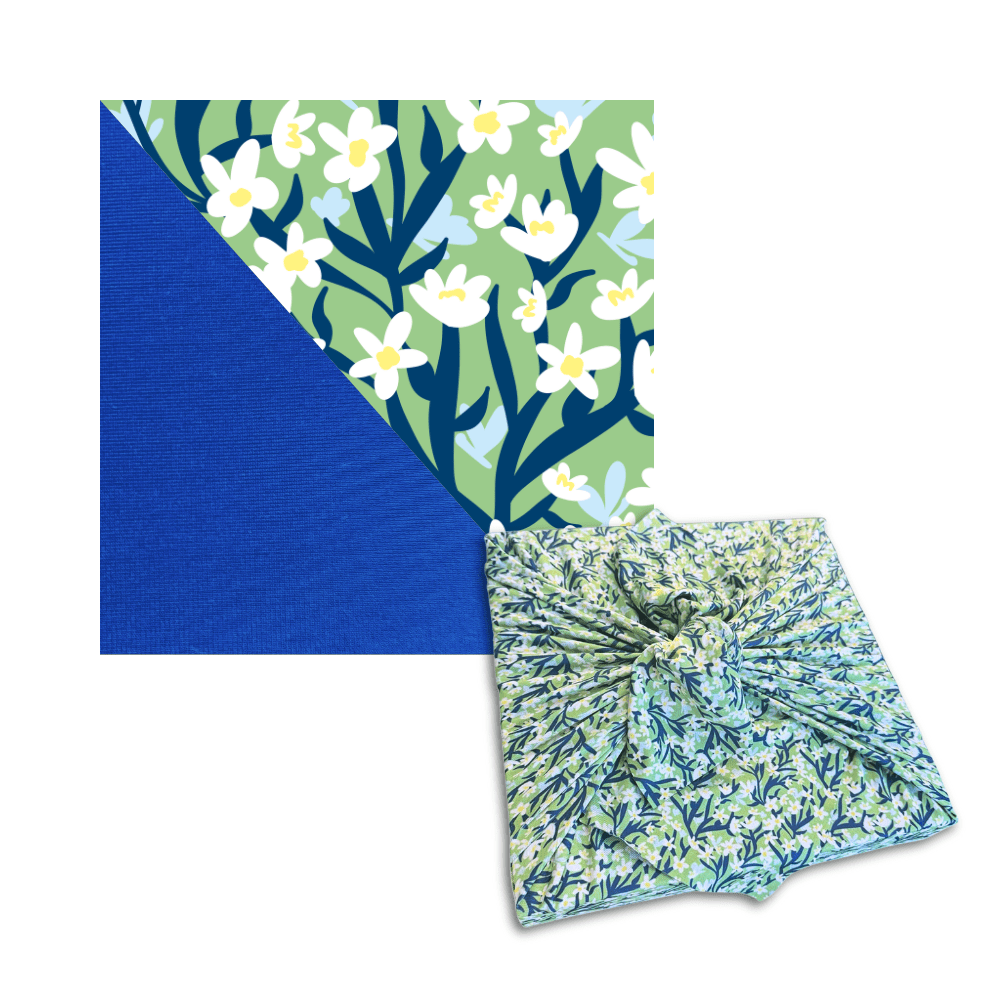 Floral leaf and white blossom reusable furoshiki wrap with tied knot, blue and green tones