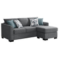 Grey upholstered sectional chaise sofa with teal pillows, tufted back, and black legs