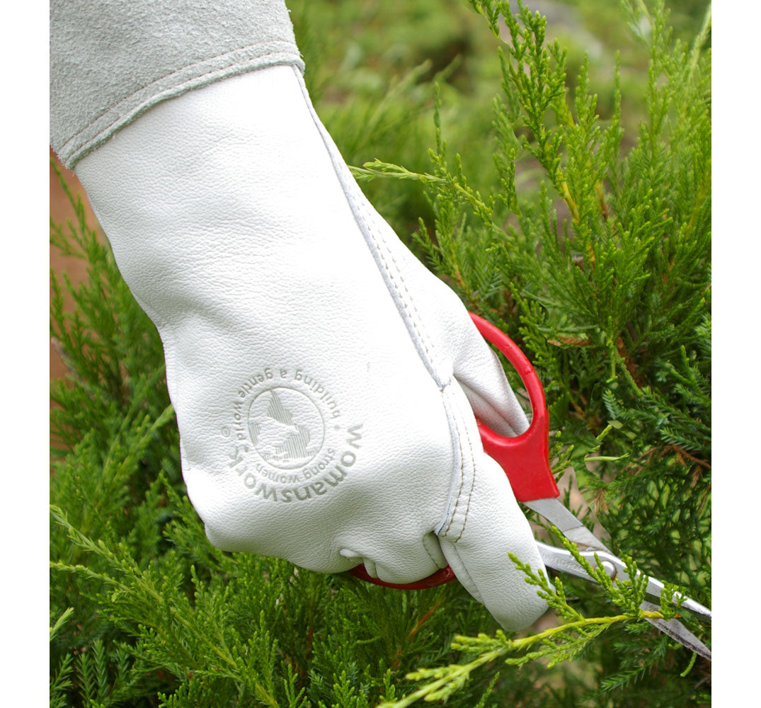 Light blue garden glove close-up with logo patch on wrist cuff, holding plant stems.