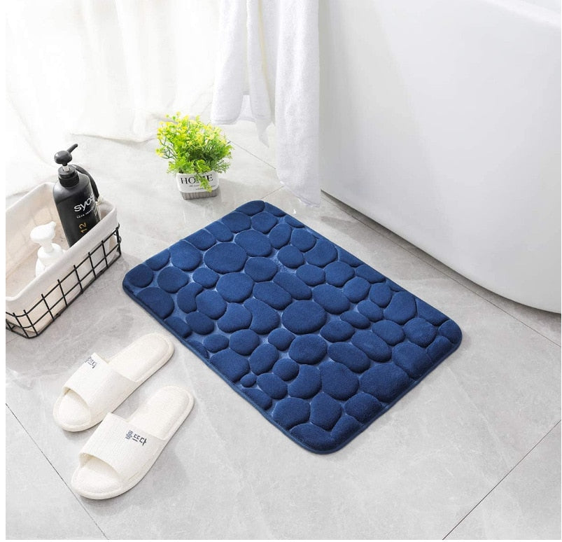 Dark blue bathroom bath mat with raised pebble-texture dots, non-slip backing