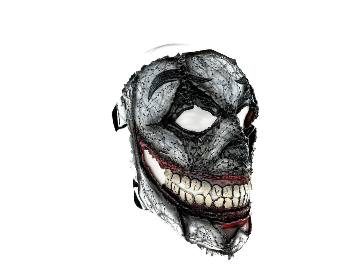 Handcrafted full-face leather mask, gray distressed finish, red trim, bared tooth grin
