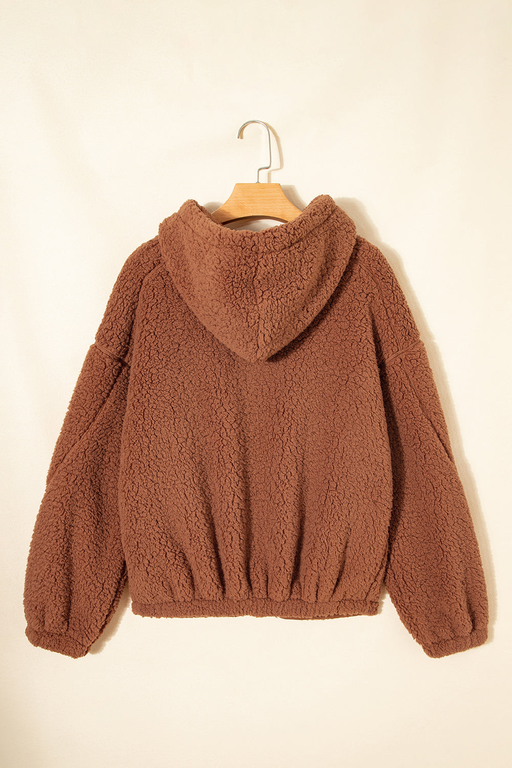 Brown sherpa fleece hooded zip-up jacket on a hanger, back view