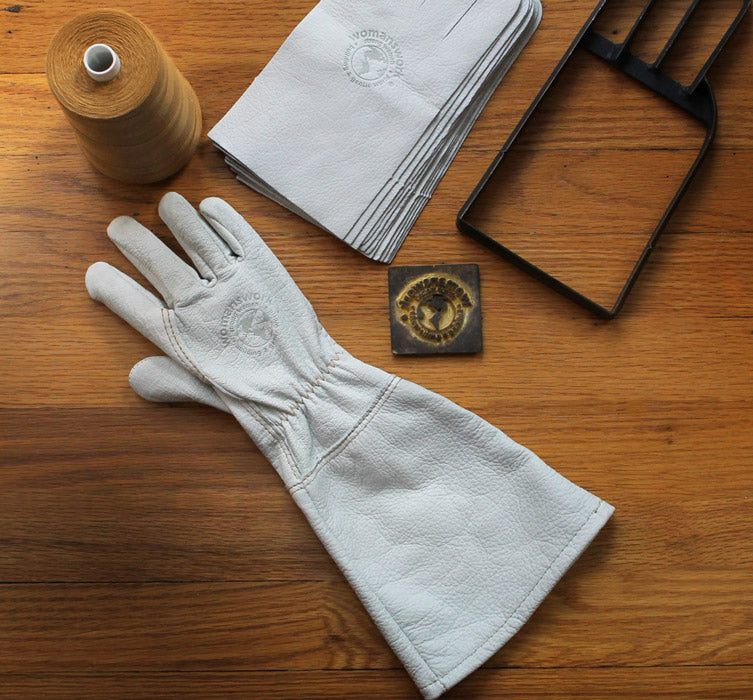 White goatskin gauntlet gloves with embossed emblem on back and long cuff