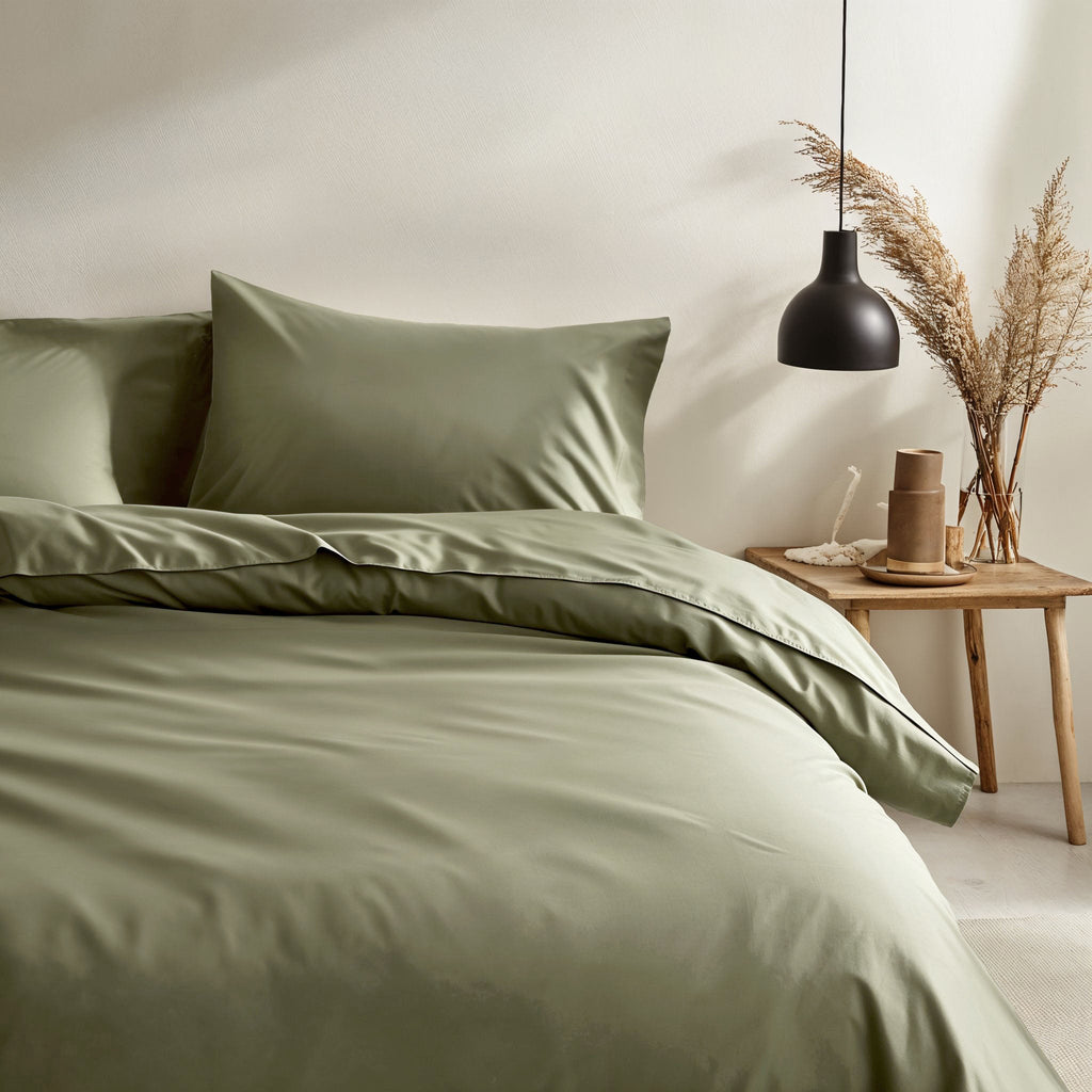 Moss green sateen duvet and pillow shams in a coordinated bedding bundle