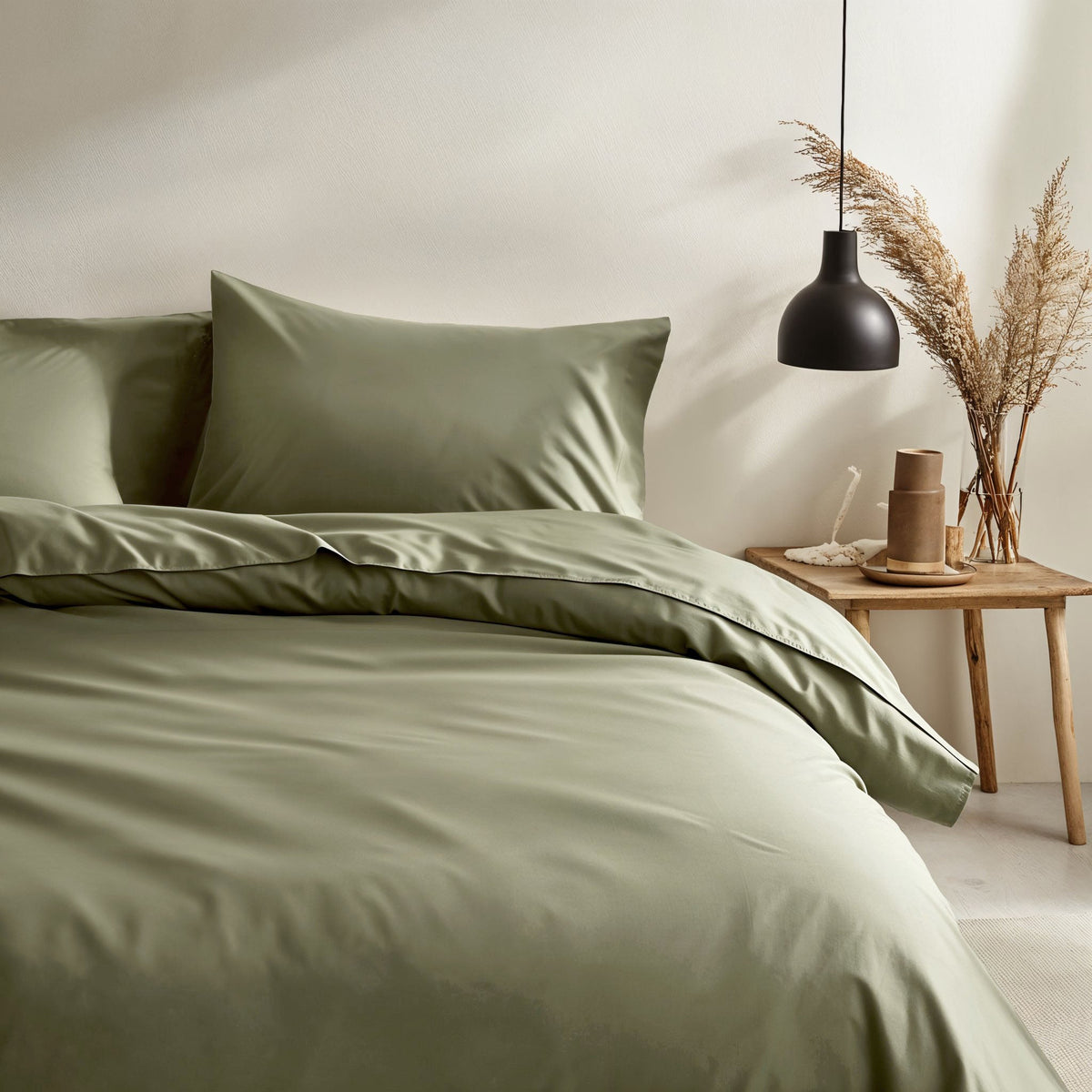 Moss green sateen duvet and pillow shams in a coordinated bedding bundle