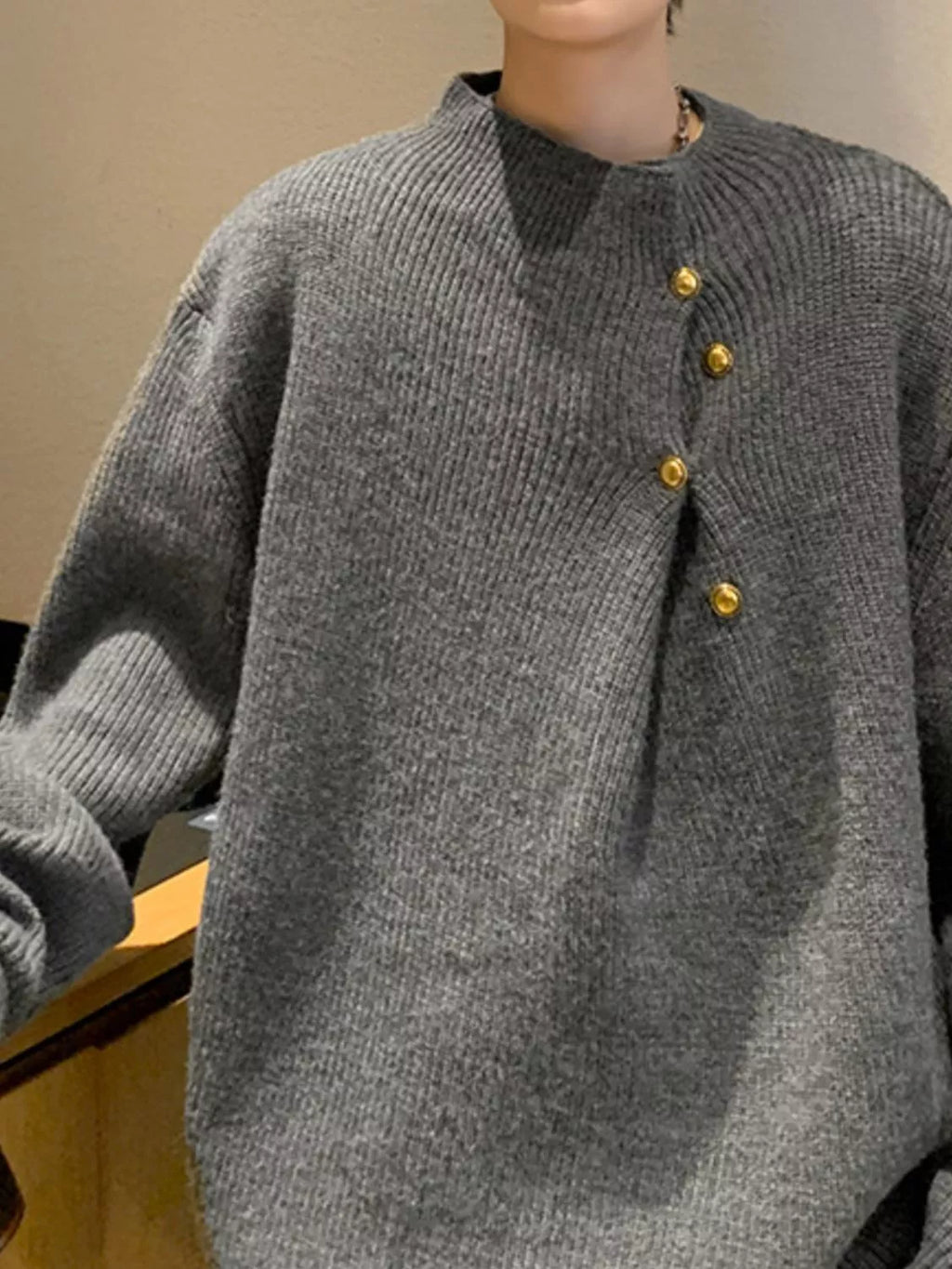 Men's gray knit sweater with ribbed cuffs and front gold-tone button accents