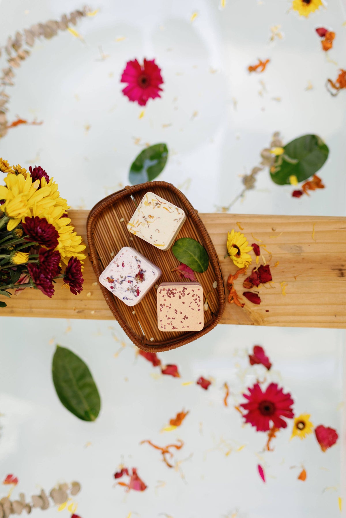 Set of square bath bombs in a wooden tray, white cubes with dried flower toppings