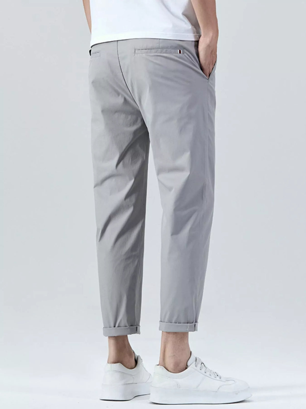 Men's straight-leg cropped pants in light gray with belt loops and button closure