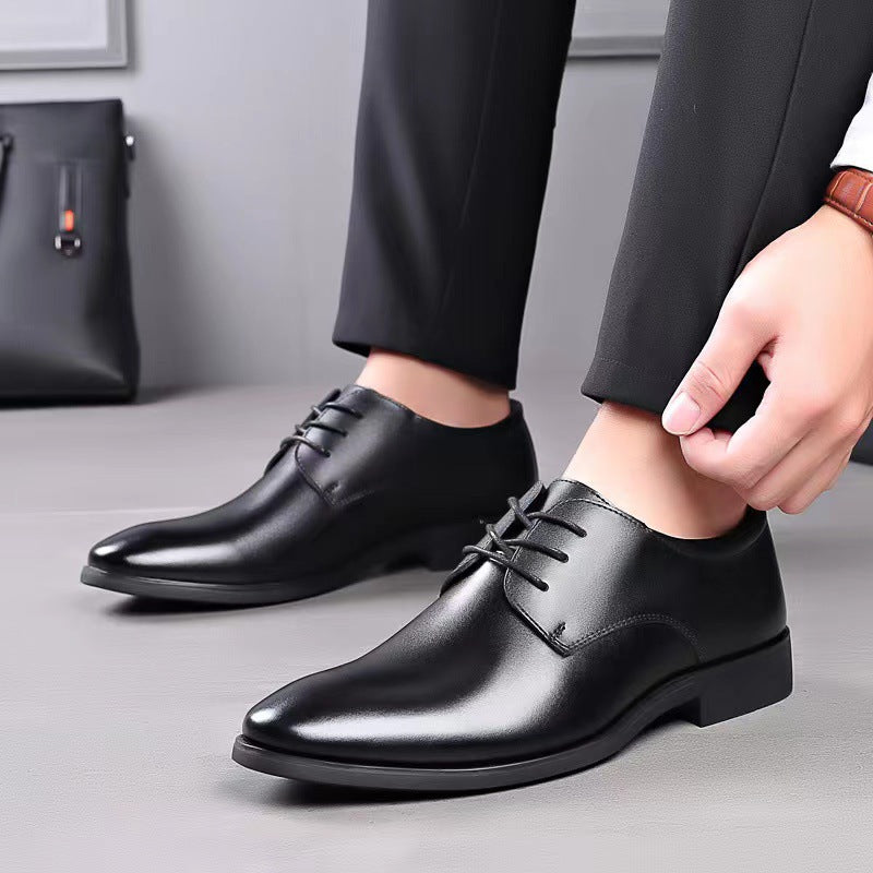 Men's black leather lace-up dress shoes on model with trouser cuff.