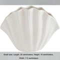 White ribbed ceramic shell vase with scalloped rim, empty centerpiece