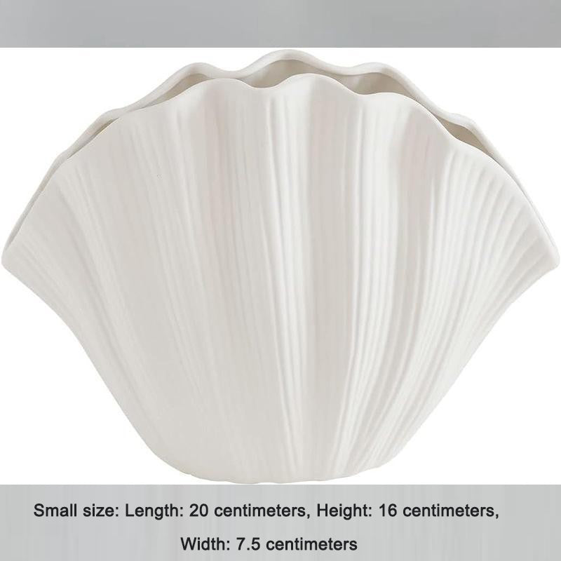 White ribbed ceramic shell vase with scalloped rim, empty centerpiece