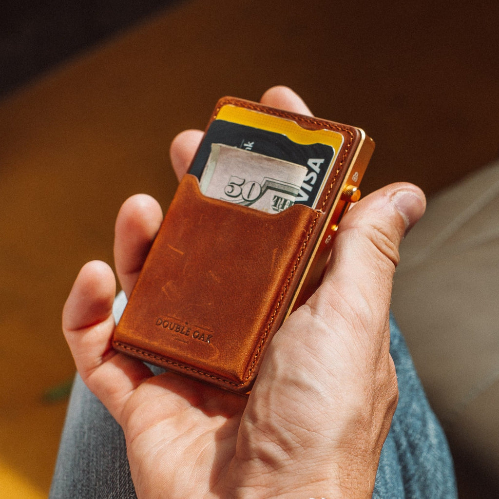 Brown leather card wallet with Visa card slot and gold-toned metal clasp
