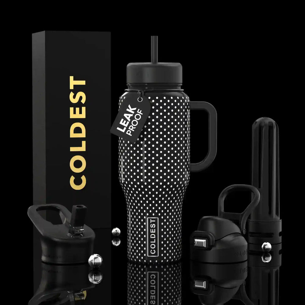 Black insulated tumbler with white polka dots, handle, straw, and leakproof lid.