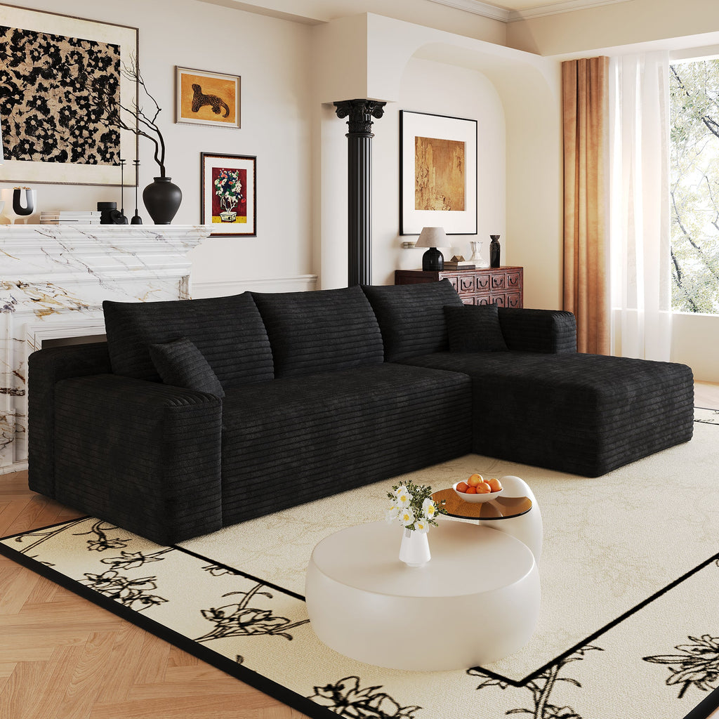 Wide dark corduroy sectional sofa with chaise and back cushions, angled view