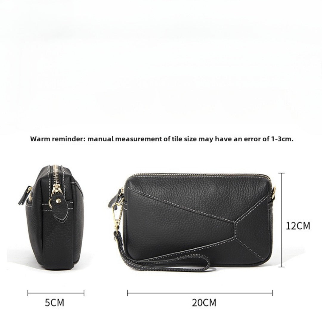 Black leather wristlet crossbody bag with zip top and detachable strap