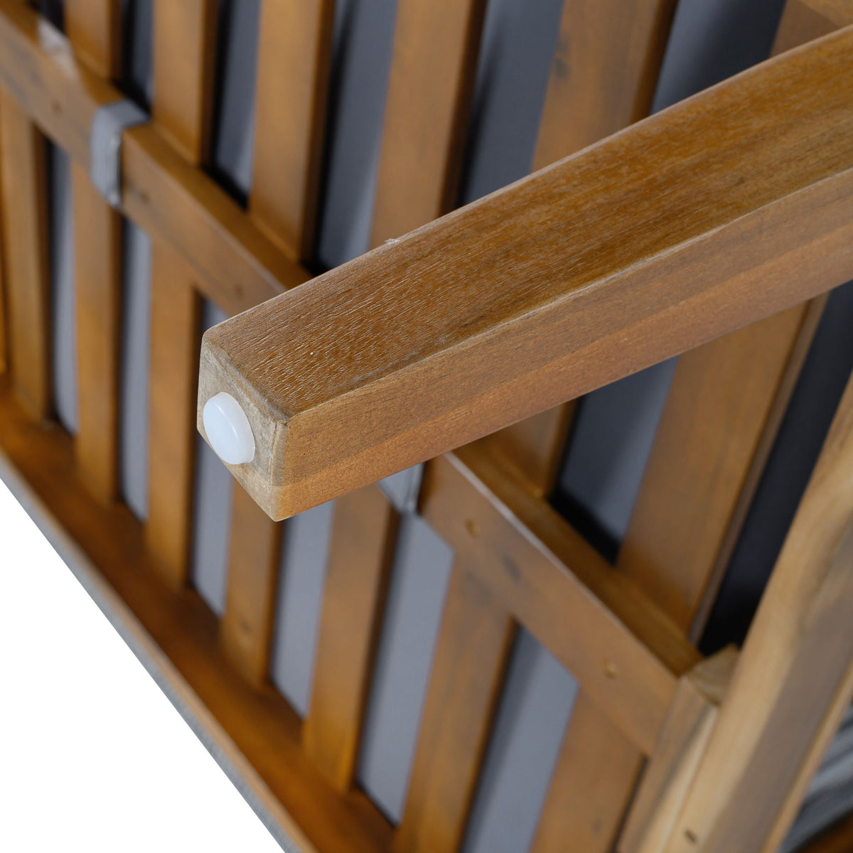 Acacia wood armrest close-up with smooth rounded edge