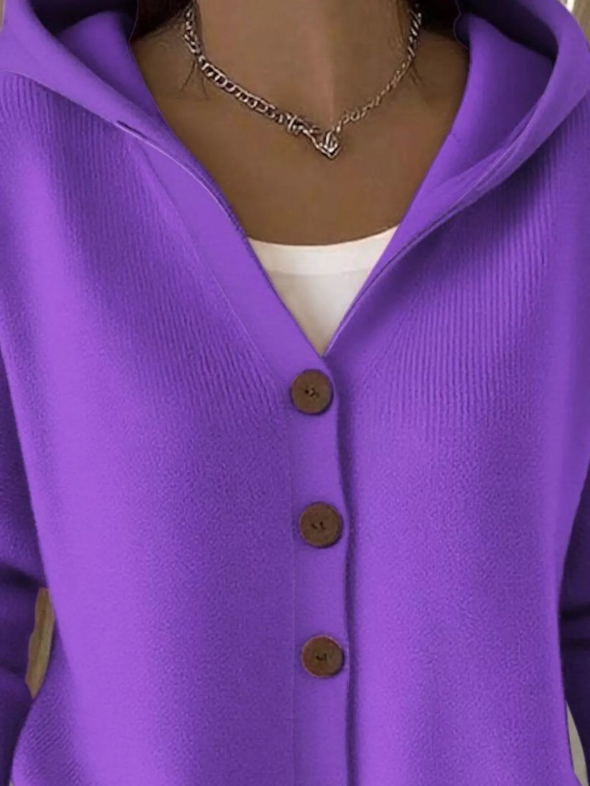 Purple hooded knit cardigan close-up of brown buttons and hood neckline