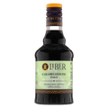 Caramelized fig syrup bottle with amber cap and dark glass body, front label visible