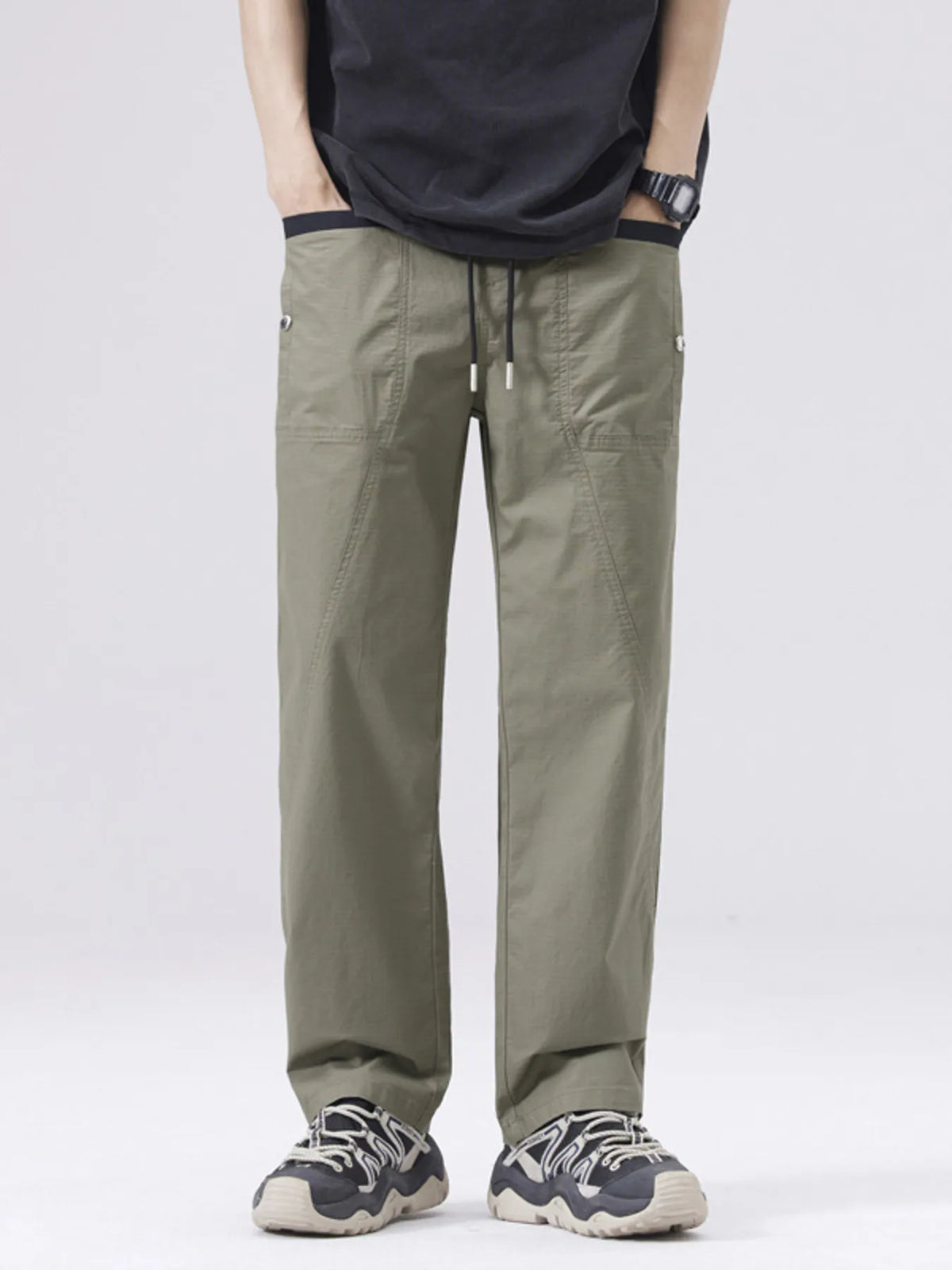 Men's army green drawstring cargo pants with side pockets and cuffed hems.
