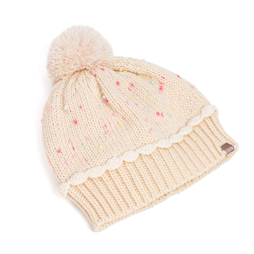 Cream knit beanie hat with pastel speckles, scalloped edge, and fluffy pom