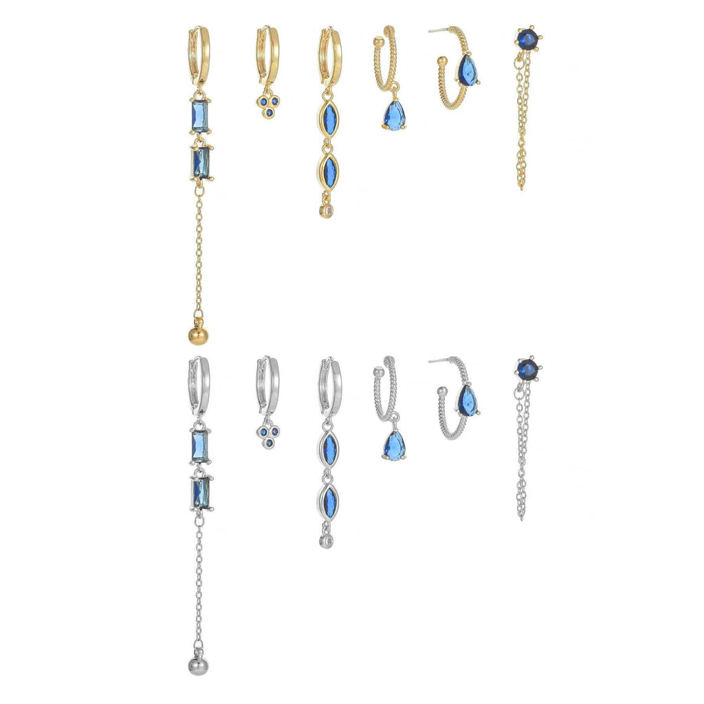 Long tassel earrings set with blue teardrop stones and chain dangles, gold- and silver-tone