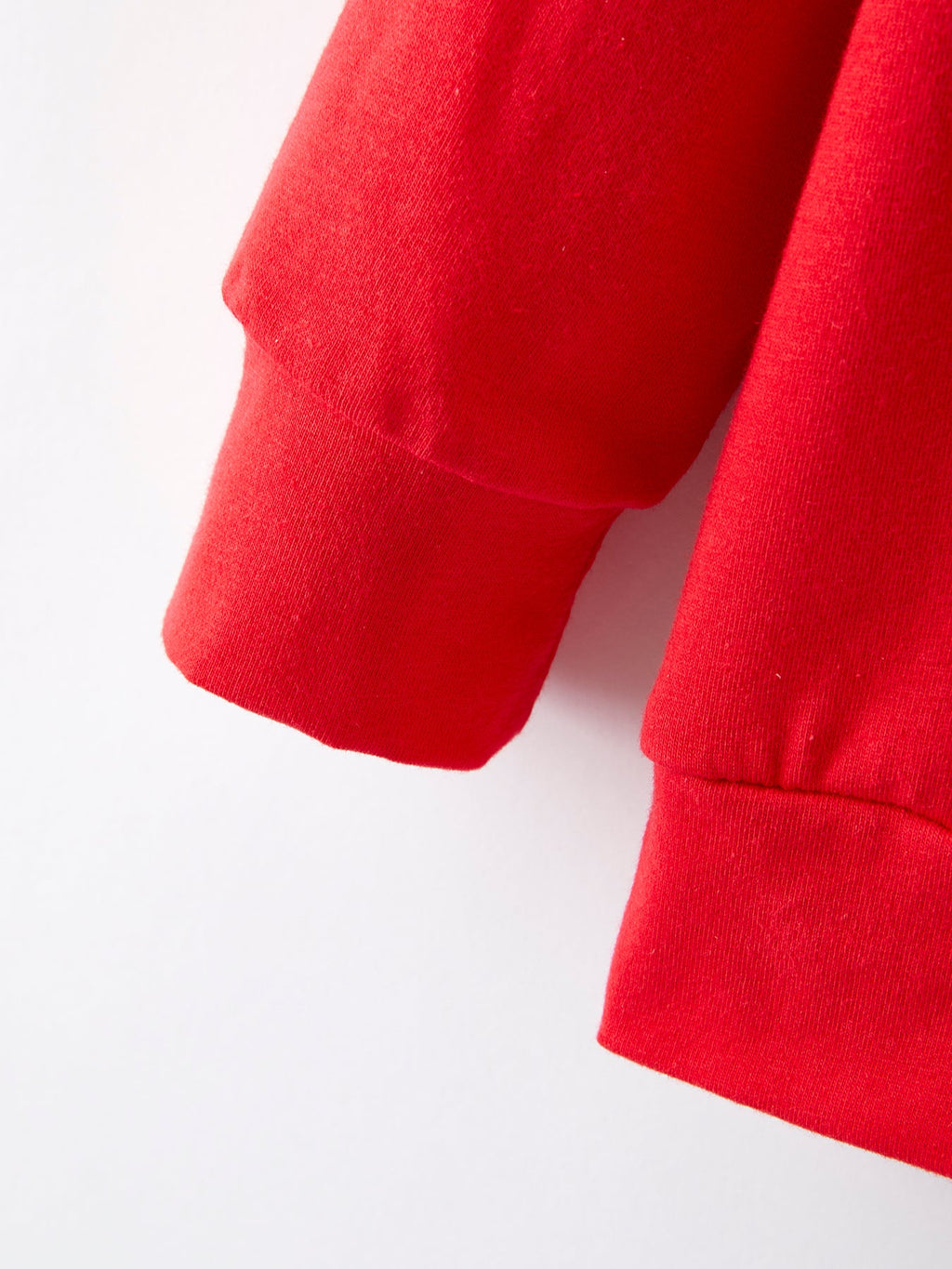 Girls red long-sleeve top with ribbed cuff, part of striped bell-bottom set
