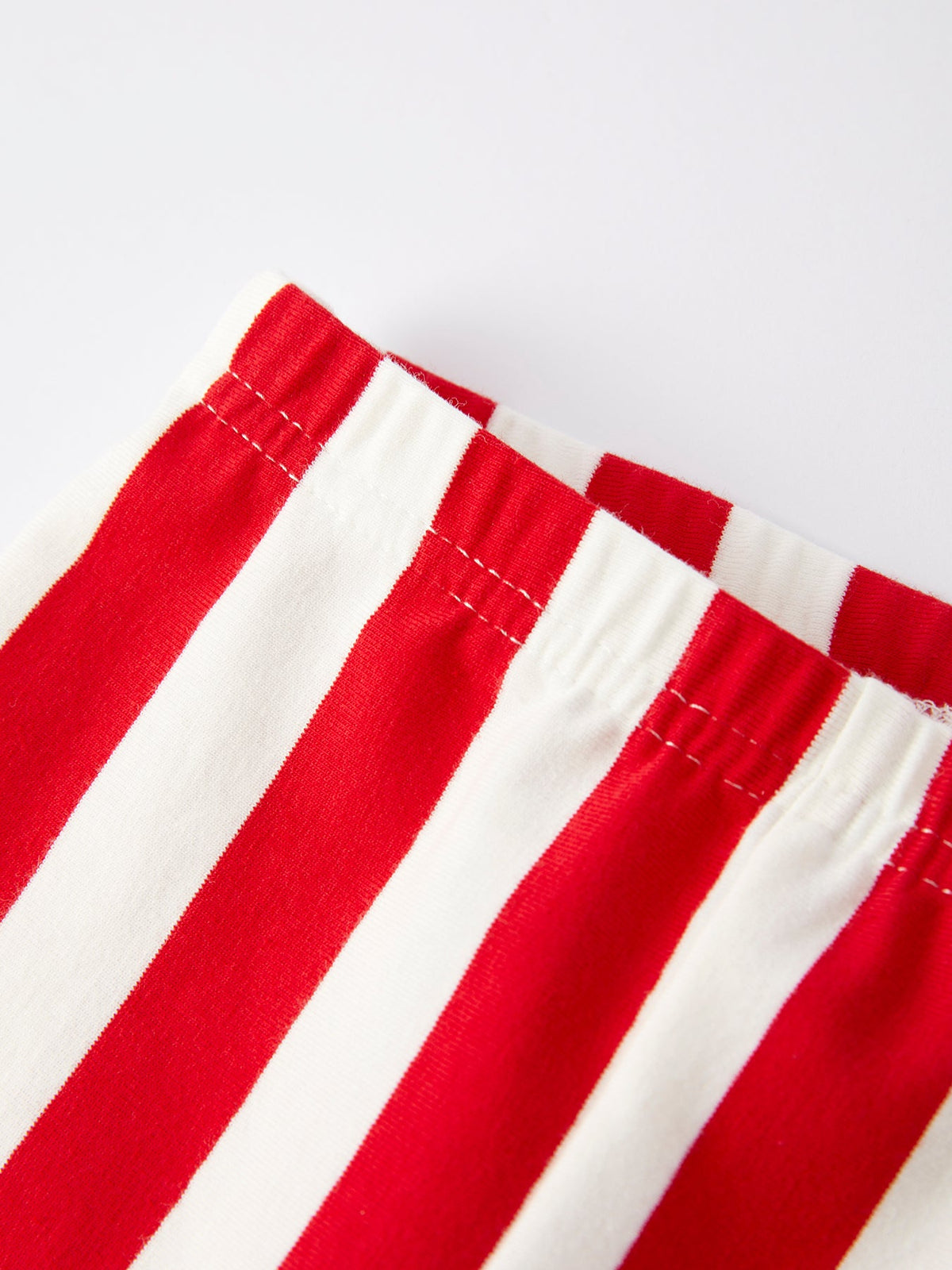 Red-and-white vertical striped bell-bottom pants with stitched waistband